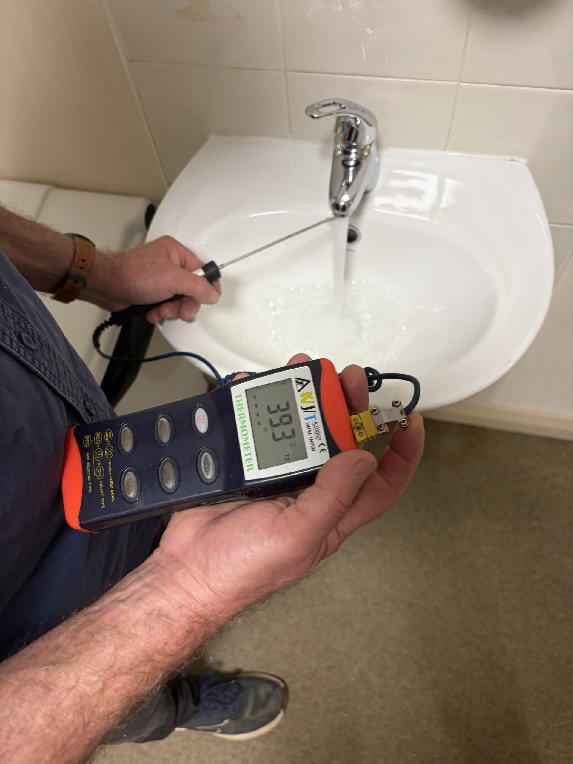 taking water temperature with a digital thermometer
